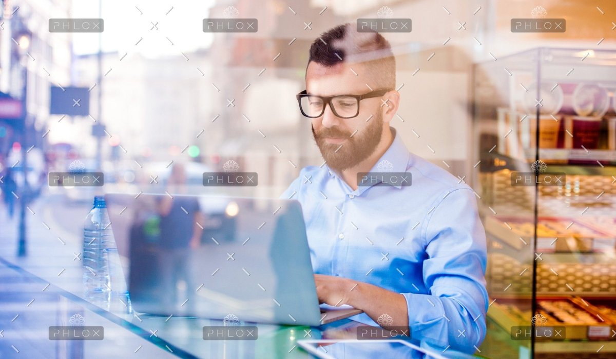 demo attachment 146 hipster manager in cafe working on laptop by window